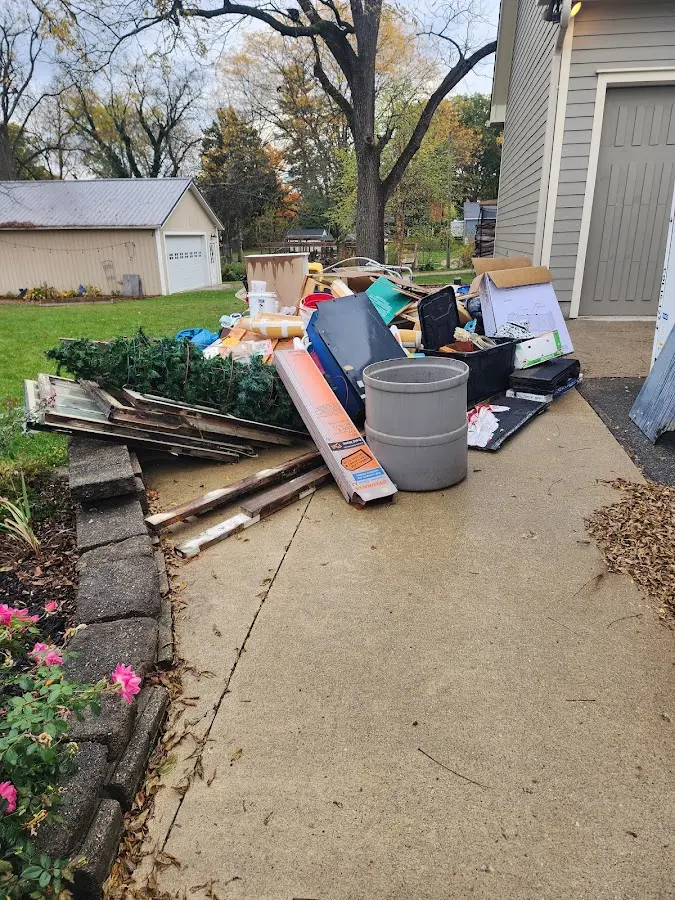 Dumpster being loaded with debris for Estate Cleanout Dumpster Rental in Moosic